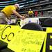 Michigan fan Gary Myers, of Denver, Colorado, distributes the signs he made over two rows of seats before the start of Michigan's Elite Eight game against Florida at Cowboys Stadium on Sunday, March 31, 2013. Melanie Maxwell I AnnArbor.com